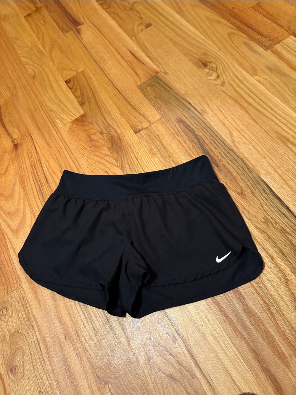 Nike women’s Black Athletic Running Shorts with White Swoosh; Size Medium